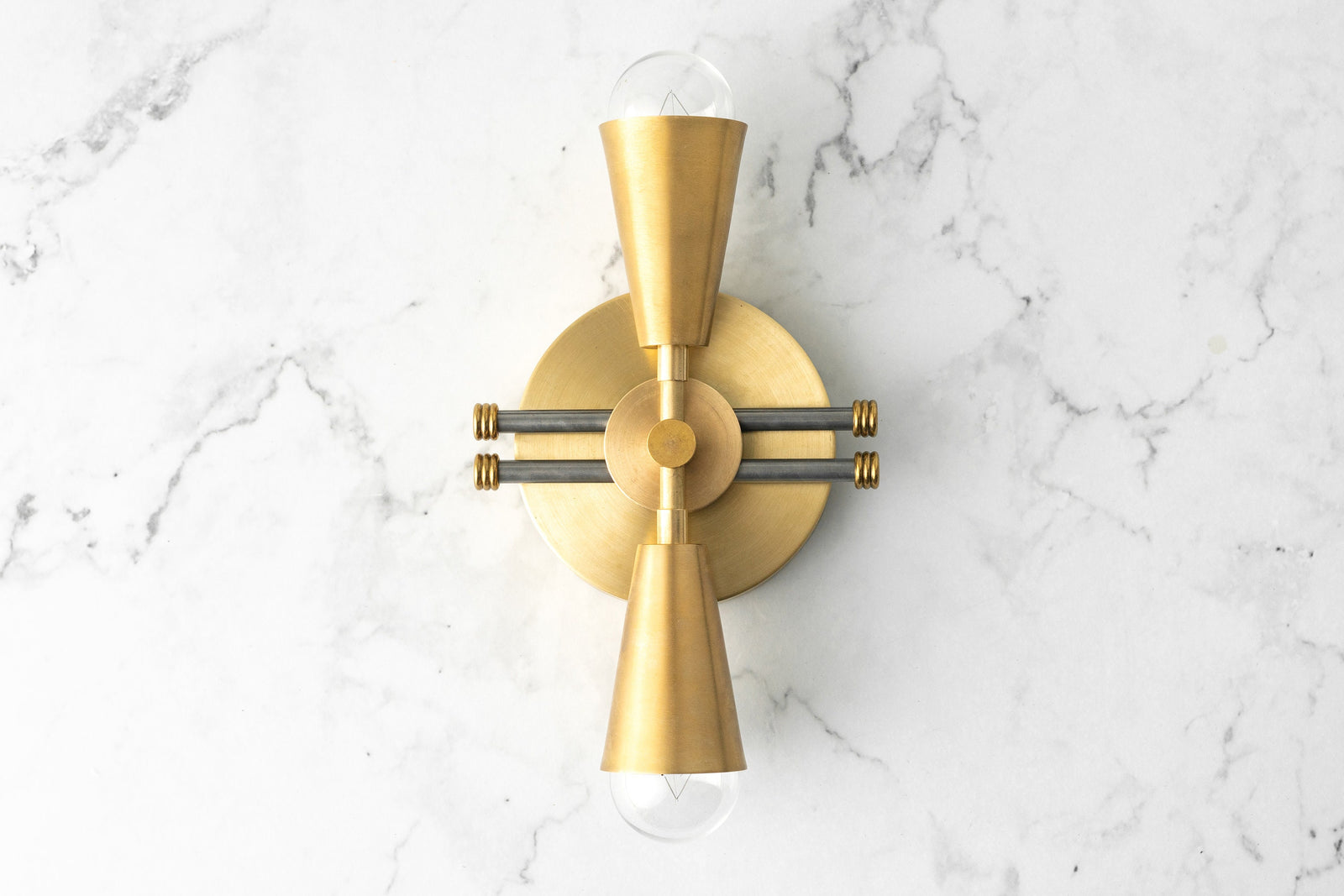 Art Deco style wall sconce in raw brass with dual exposed bulbs and horizontal black steel rods. - SCONCE MODEL NO. 3419