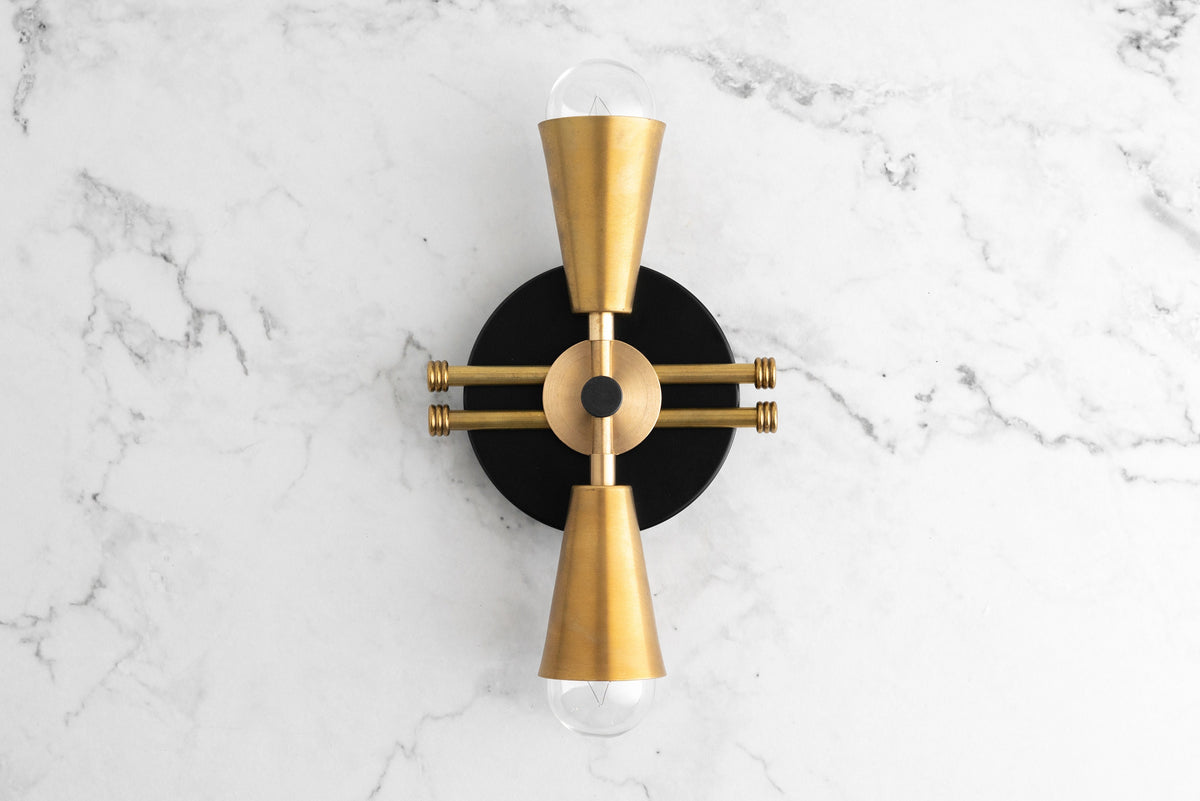 Art Deco black and raw brass up/down wall sconce with exposed bulbs on marble background. - SCONCE MODEL NO. 3419