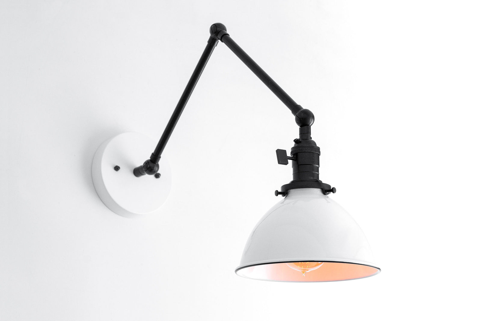 Adjustable black industrial wall sconce with white metal shade and exposed vintage bulb. - SCONCE MODEL NO. 8551