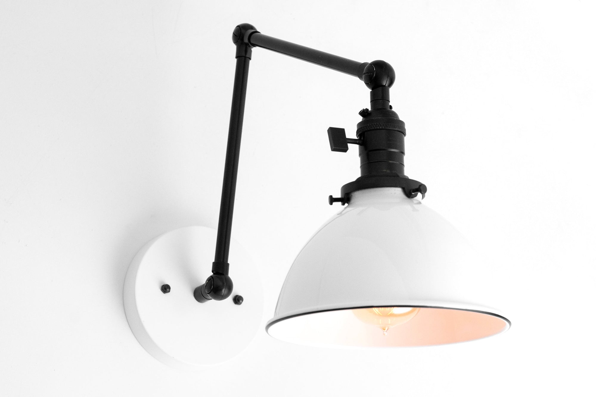 Adjustable black industrial wall sconce with white metal shade and round white mounting plate. - SCONCE MODEL NO. 8551