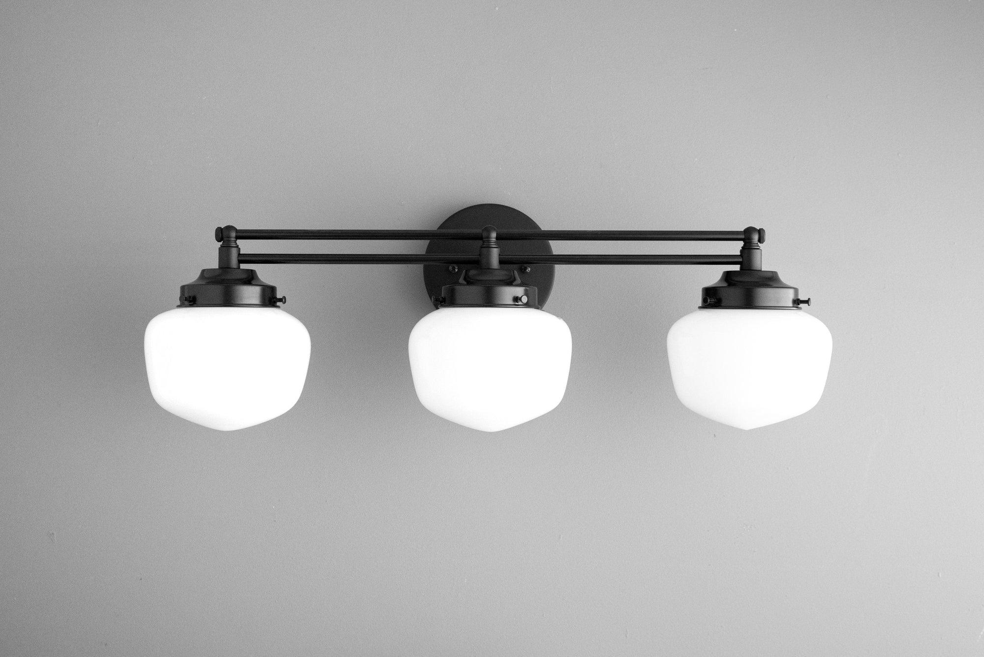 3-bulb vanity light with black metal frame and frosted globe shades in Art Deco style. - VANITY LIGHT MODEL NO. 4352