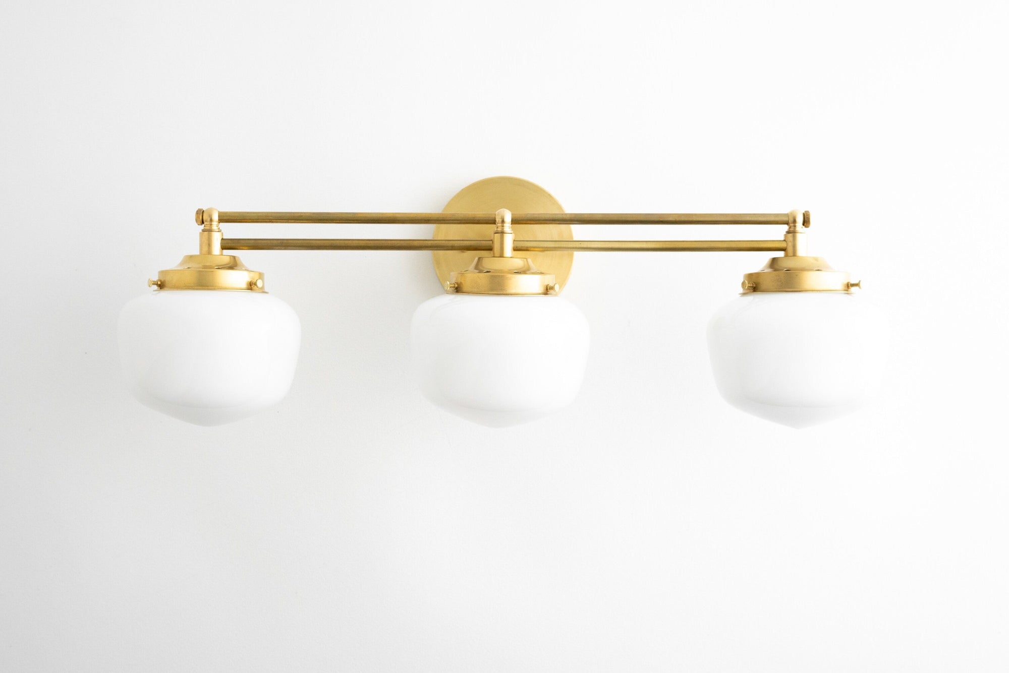 Art deco 3-bulb vanity light with round white glass globes and brass finish. - VANITY LIGHT MODEL NO. 4352