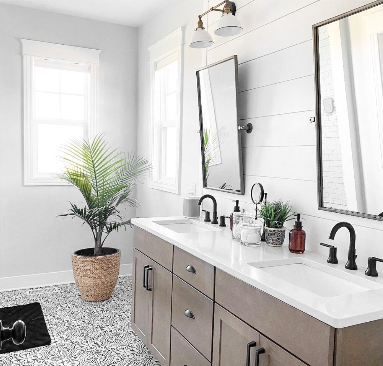 Two-bulb industrial vanity light with white shades and black finish mounted above double mirrors. - VANITY LIGHT MODEL NO. 4564