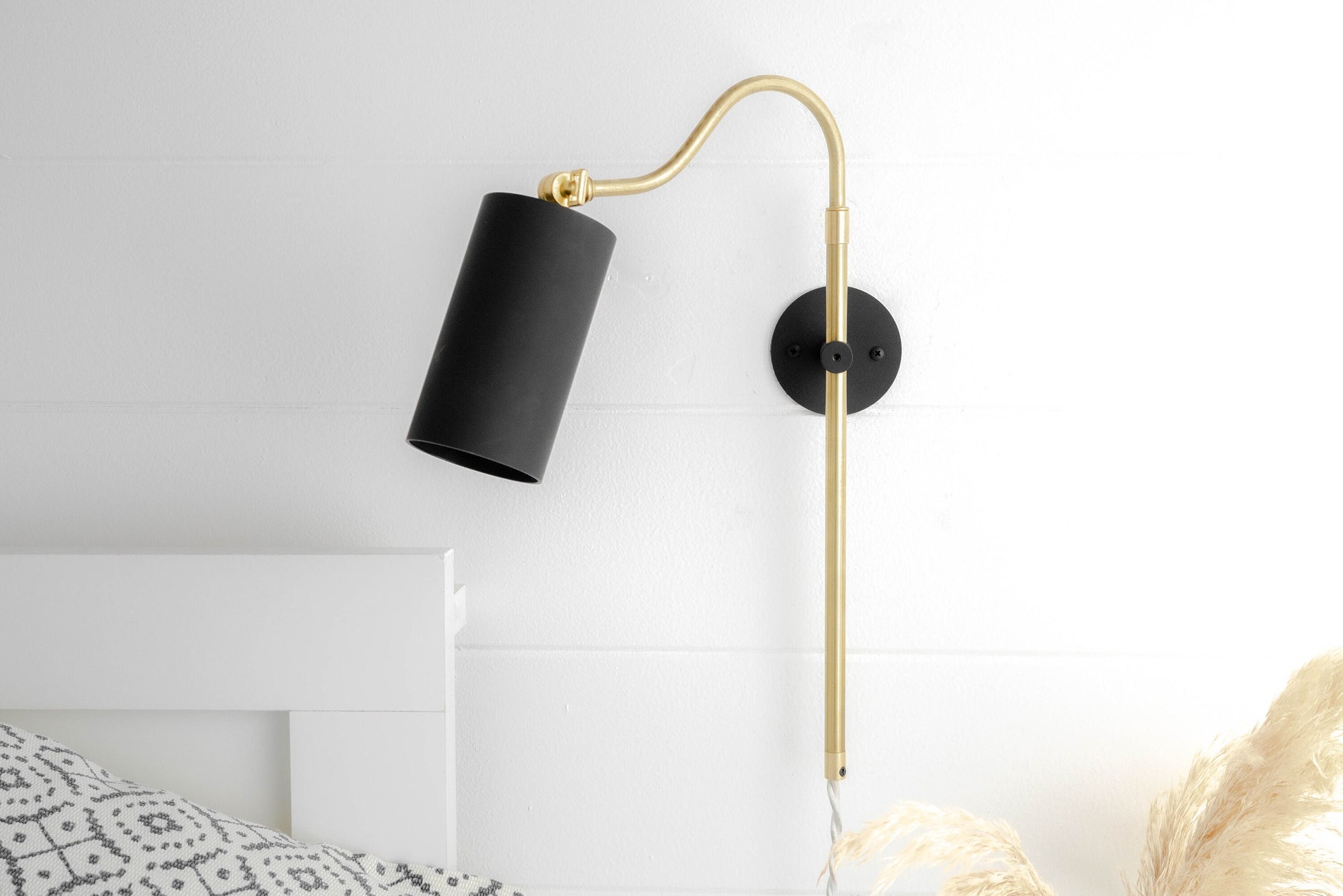 Mid-century modern wall sconce with adjustable sealed brass arm and matte black cylindrical shade. - SCONCE MODEL NO. 1132