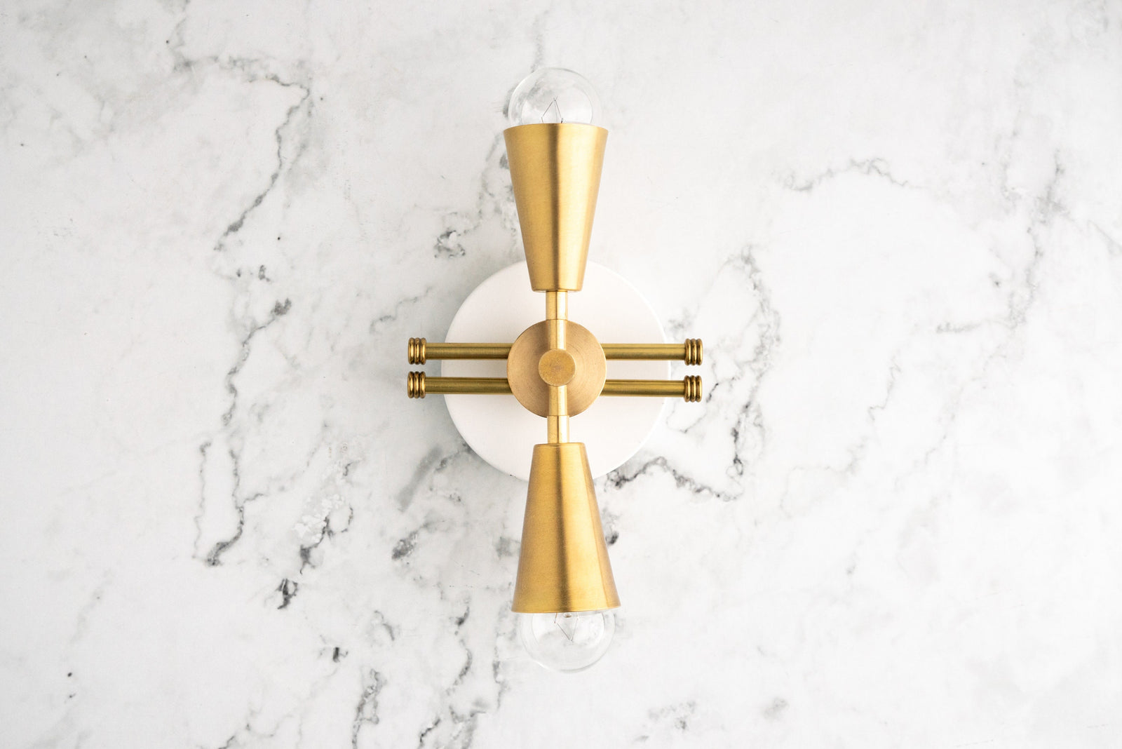Art Deco style sconce with raw brass finish, featuring upward and downward exposed bulbs and geometric design. - SCONCE MODEL NO. 3419