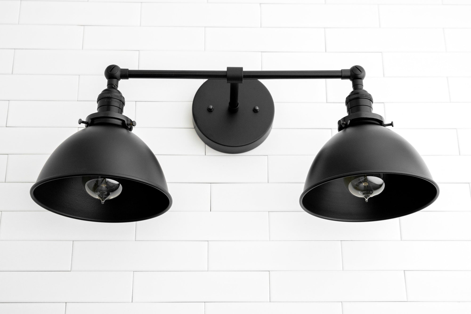 Black industrial-style 2-light vanity sconce with adjustable round shades and matte finish. - SCONCE MODEL NO. 8791