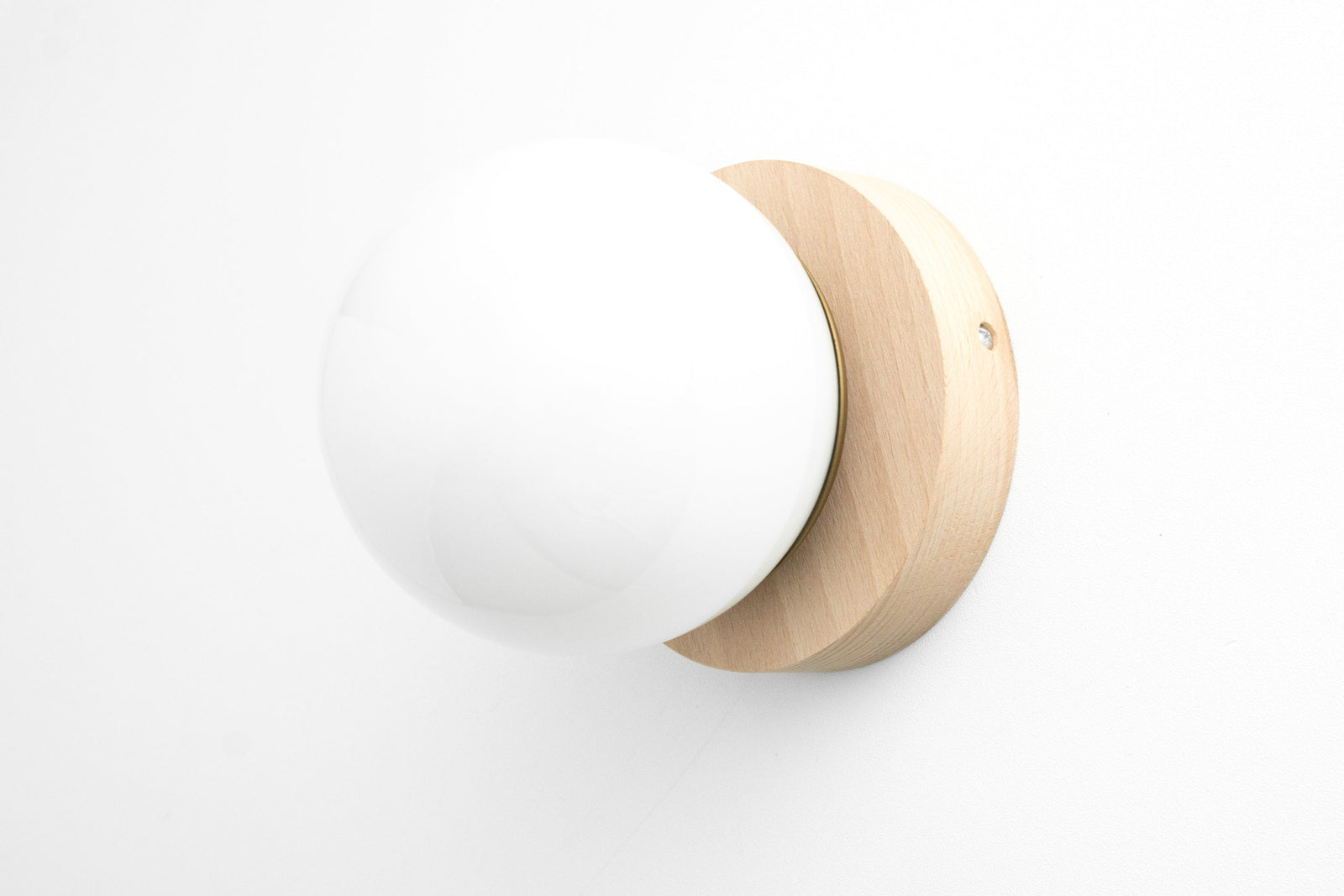Scandinavian sconce with natural beechwood base and white globe light flush mounted on wall. - SCONCE MODEL NO. 5719