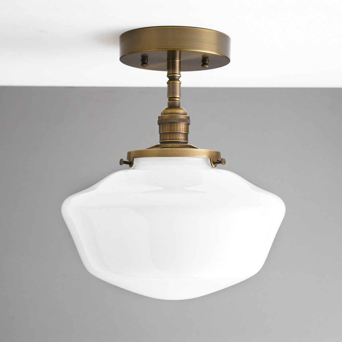 Semi-flush ceiling light with an antique brass finish and a white curvy glass globe shade. - CEILING LIGHT MODEL NO. 9512