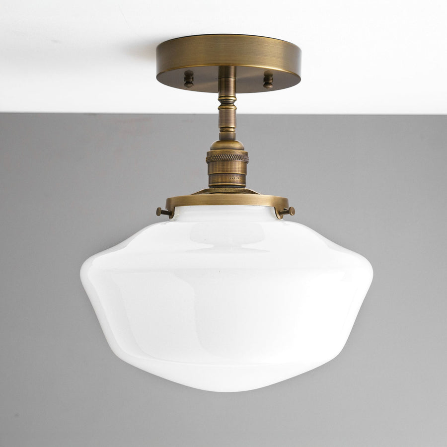 Semi-flush ceiling light with an antique brass finish and a white curvy glass globe shade. - CEILING LIGHT MODEL NO. 9512