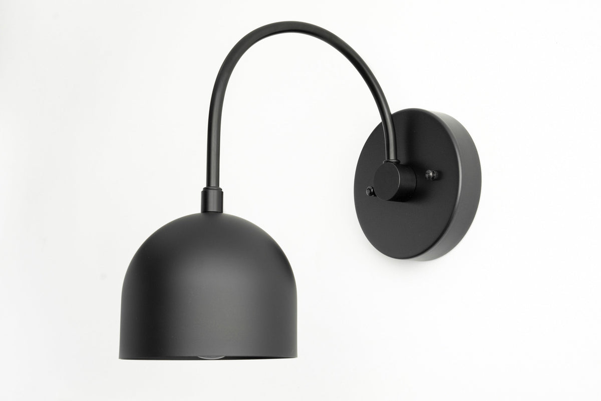 Matte black metal wall sconce with curved arm and dome-shaped shade. - SCONCE MODEL NO. 8586