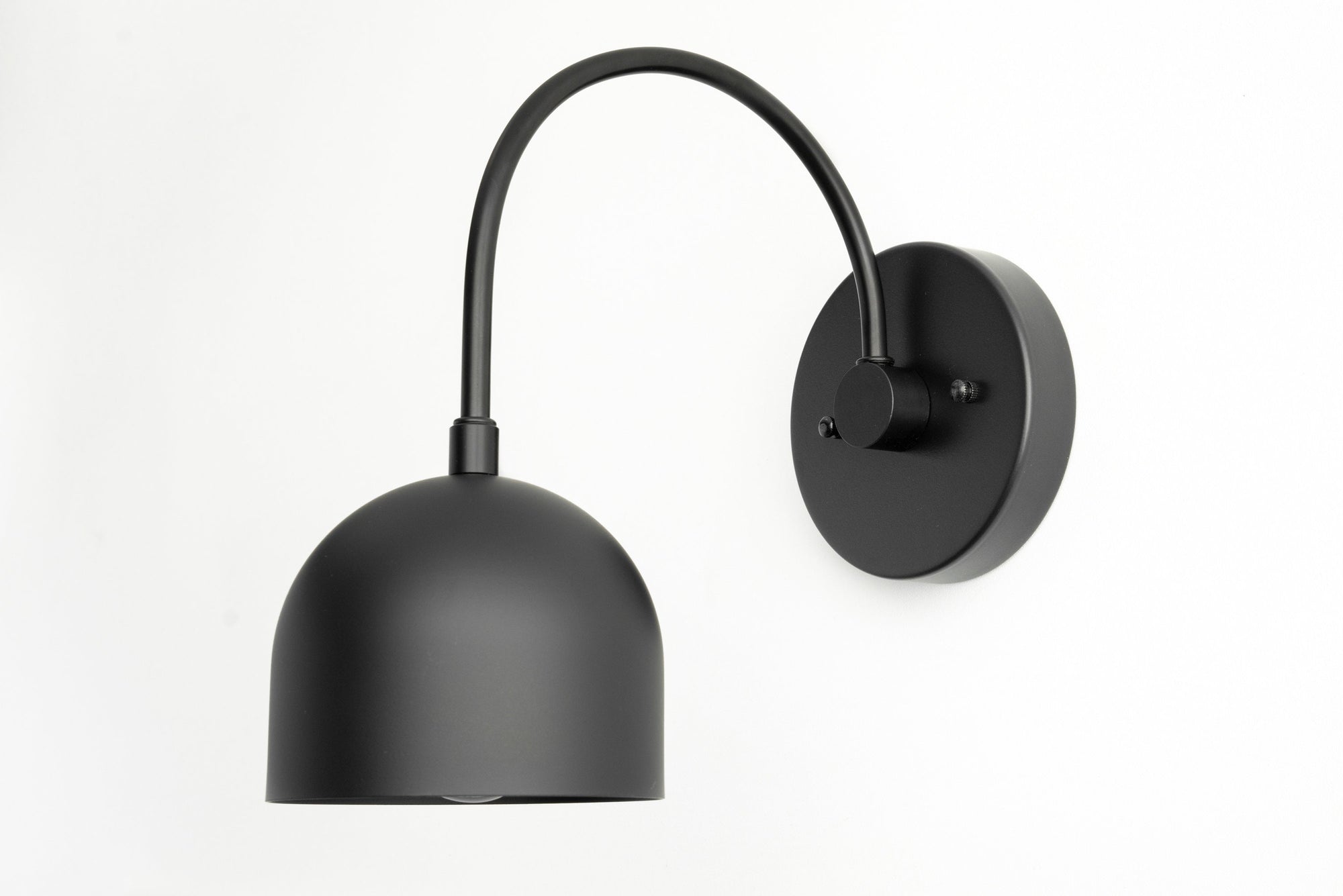 Matte black metal wall sconce with curved arm and dome-shaped shade. - SCONCE MODEL NO. 8586
