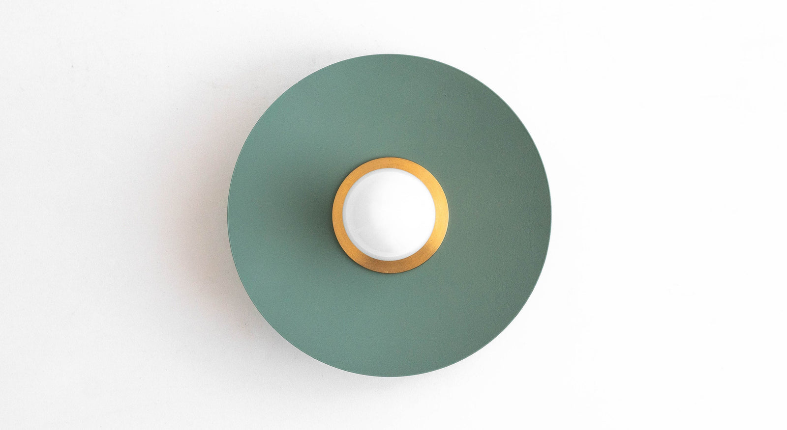 Raw brass and matte green Scandinavian-style flush sconce with bare bulb centered on round backplate. - SCONCE MODEL NO. 9660