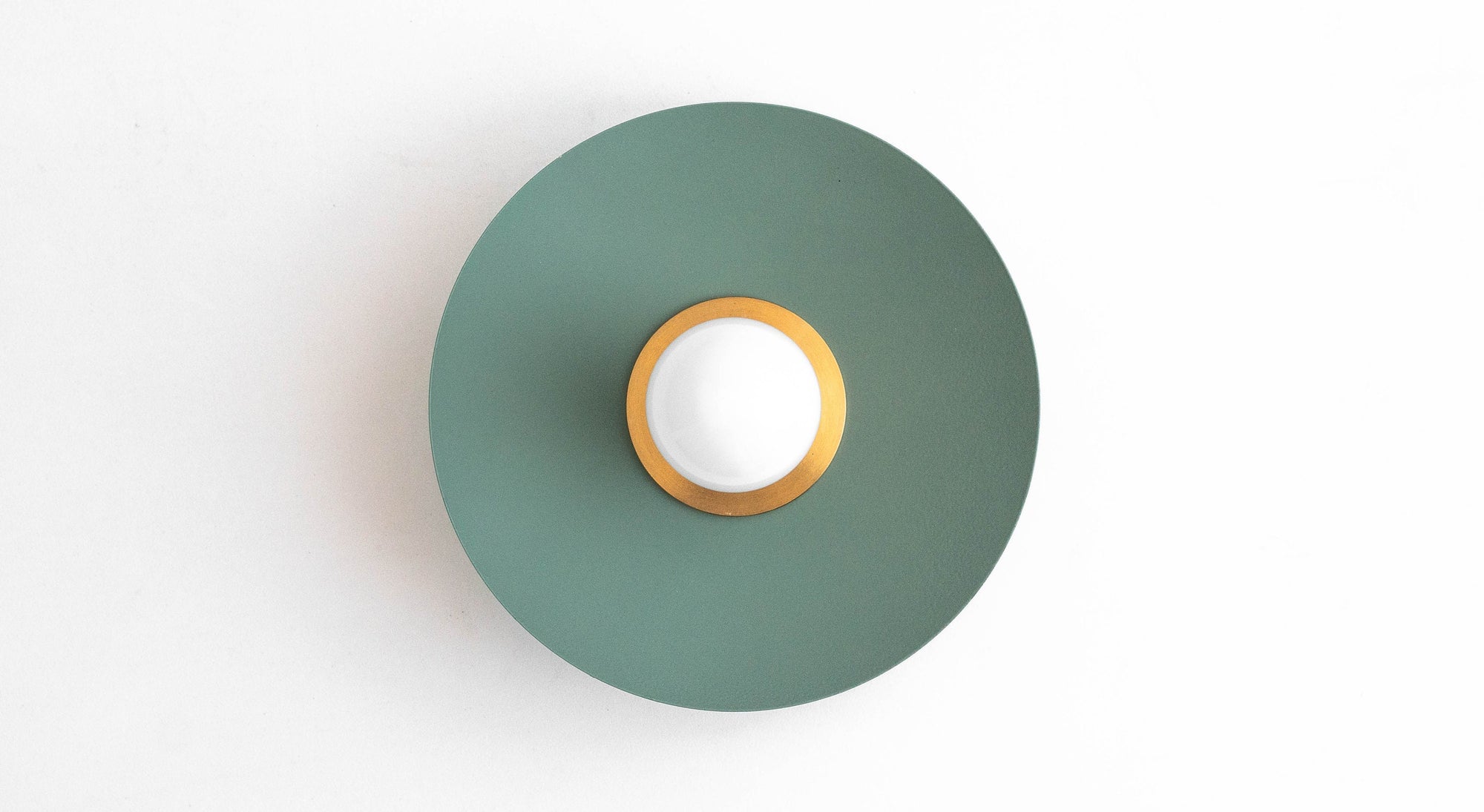 Raw brass and matte green Scandinavian-style flush sconce with bare bulb centered on round backplate. - SCONCE MODEL NO. 9660