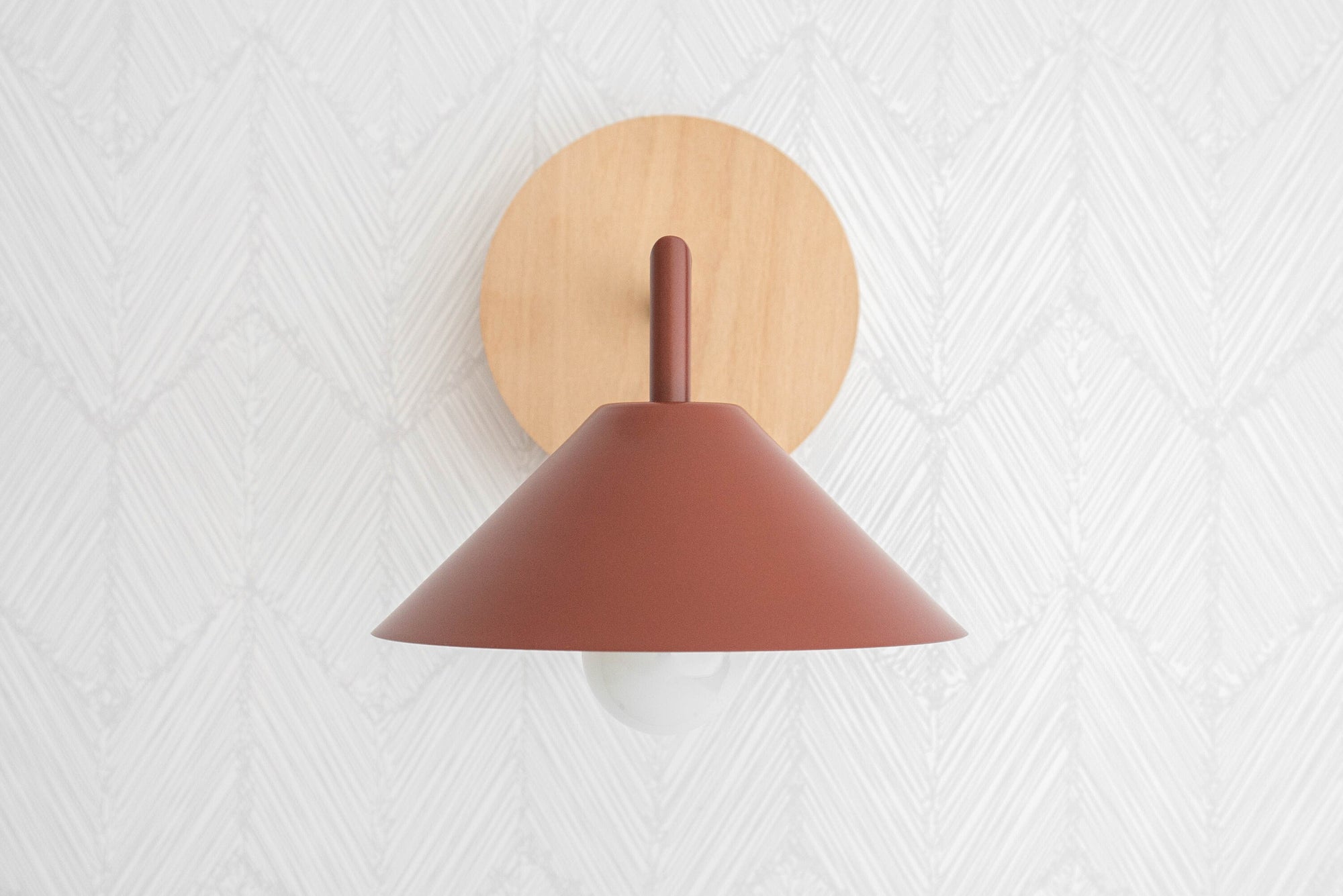 Beechwood wall sconce with brick red conical shade and natural wood mount on textured white wall. - SCONCE MODEL NO. 1721