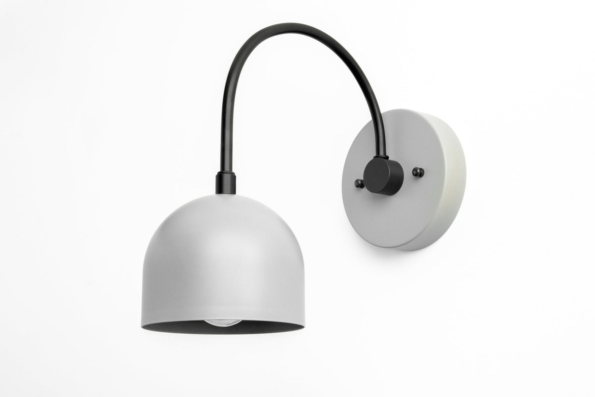 Gray metal mid-century modern sconce with dome shade and curved black arm mounted on gray circular base. - SCONCE MODEL NO. 8586
