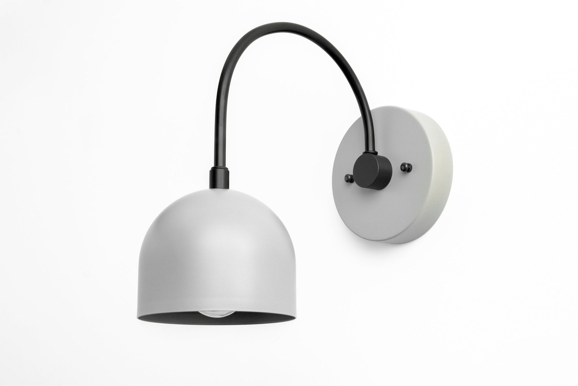 Gray metal mid-century modern sconce with dome shade and curved black arm mounted on gray circular base. - SCONCE MODEL NO. 8586