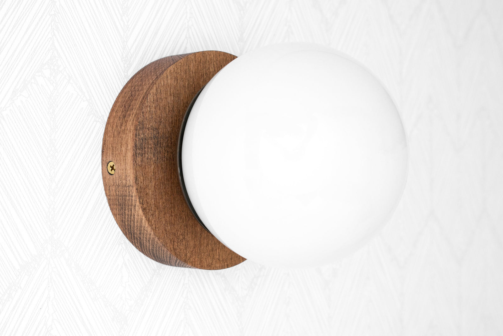 Wall-mounted sconce with round white glass globe and natural wood base in warm brown finish. - SCONCE MODEL NO. 5719