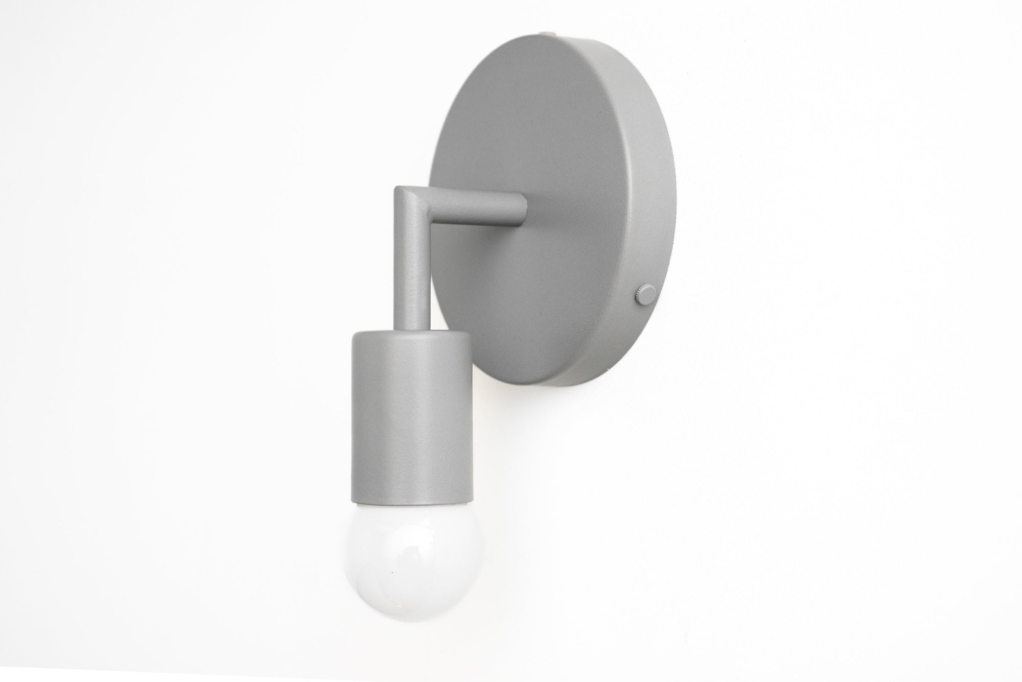 Gray Scandinavian-style wall sconce with a cylindrical holder and exposed round bulb. - SCONCE MODEL NO. 5480