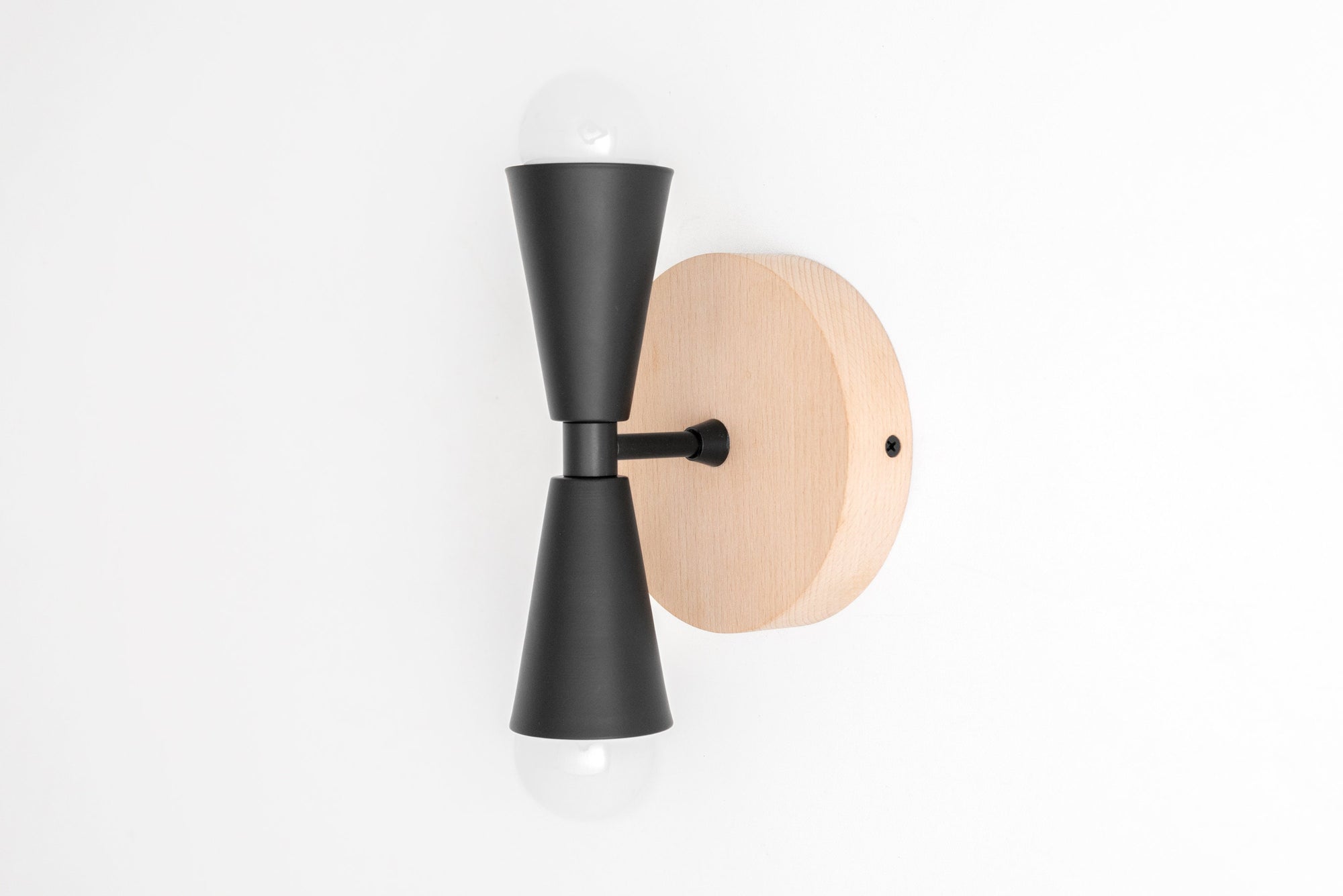 Scandinavian-style wall sconce with beechwood backplate and black metal double-cone fixture holding exposed bulbs top and. - SCONCE MODEL NO. 4717