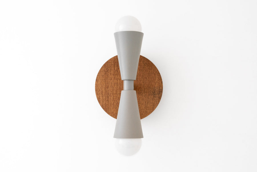 Scandinavian style wall sconce with oak wood backplate and gray double cone metal arms holding exposed bulbs. - SCONCE MODEL NO. 4717