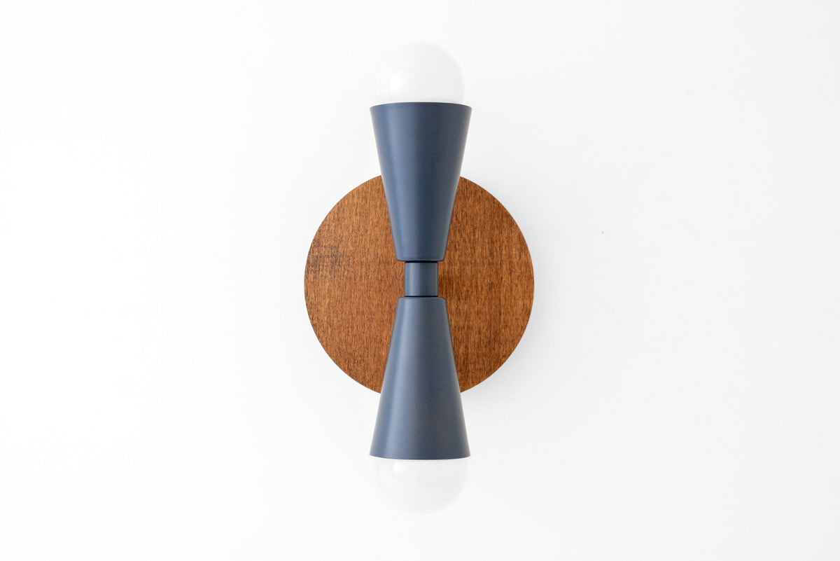Wall sconce with oak round backplate and up/down gray matte fixtures holding exposed bulbs. - SCONCE MODEL NO. 4717