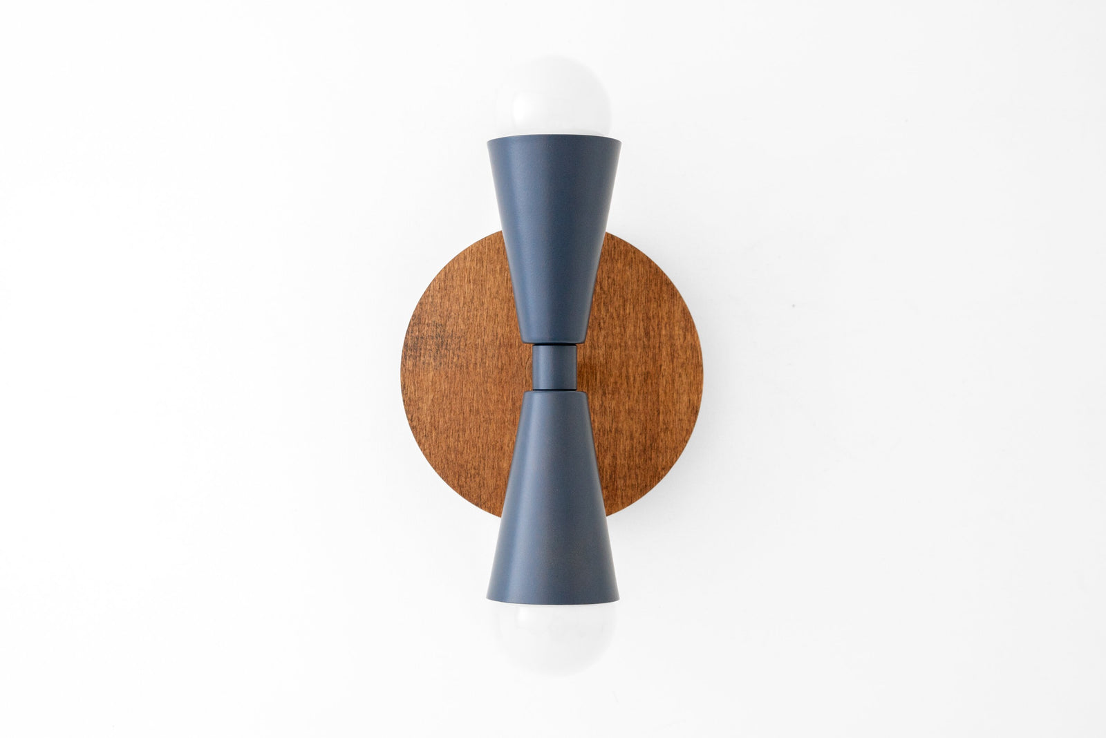 Wall sconce with oak round backplate and up/down gray matte fixtures holding exposed bulbs. - SCONCE MODEL NO. 4717