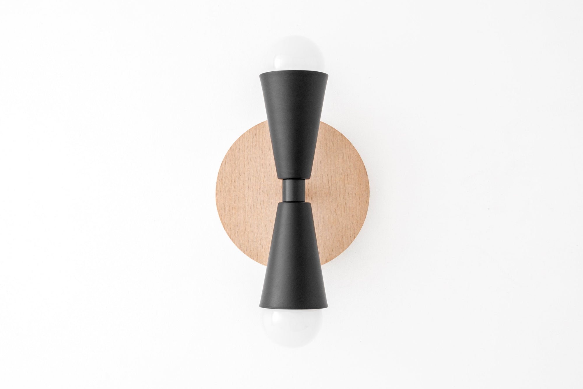 Black cone-shaped sconce with bare bulbs on beechwood round base on white wall. - SCONCE MODEL NO. 4717