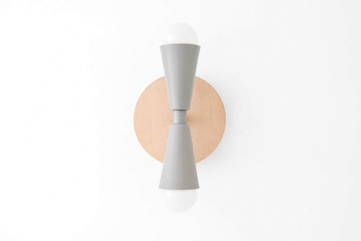 Scandinavian-style wall sconce with natural beechwood backplate and gray double cone metal shades, bare bulbs visible. - SCONCE MODEL NO. 4717