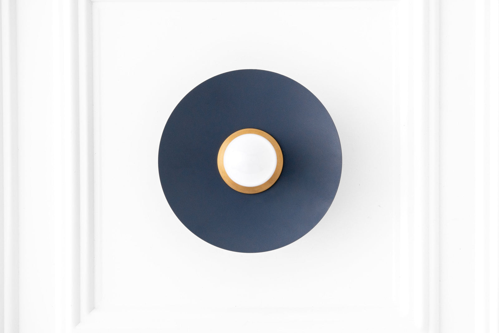 Raw brass and coal blue Scandinavian flush sconce with exposed bulb and minimalist design. - SCONCE MODEL NO. 9660
