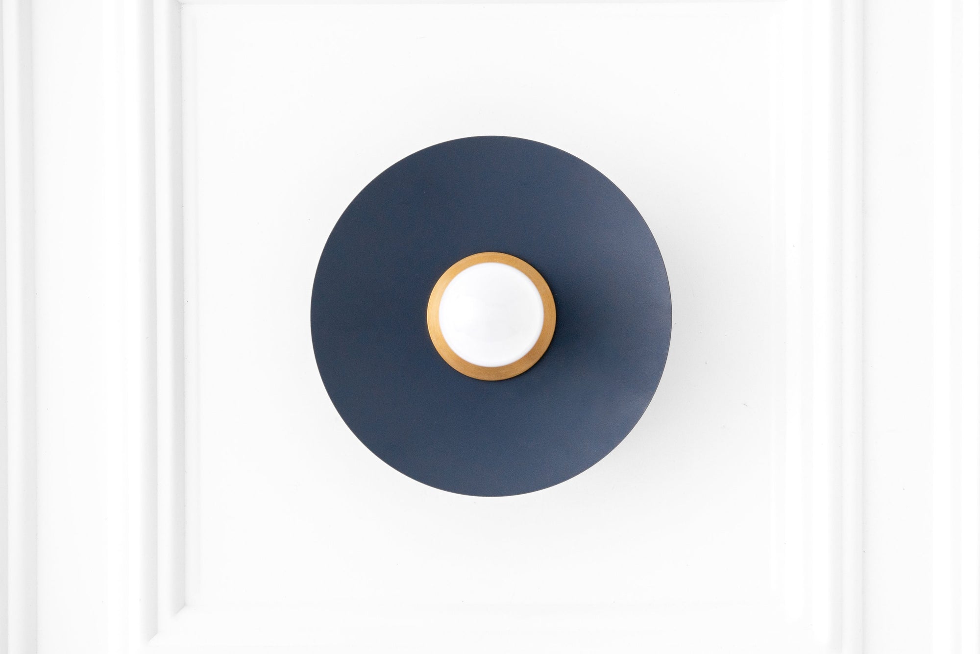 Raw brass and coal blue Scandinavian flush sconce with exposed bulb and minimalist design. - SCONCE MODEL NO. 9660