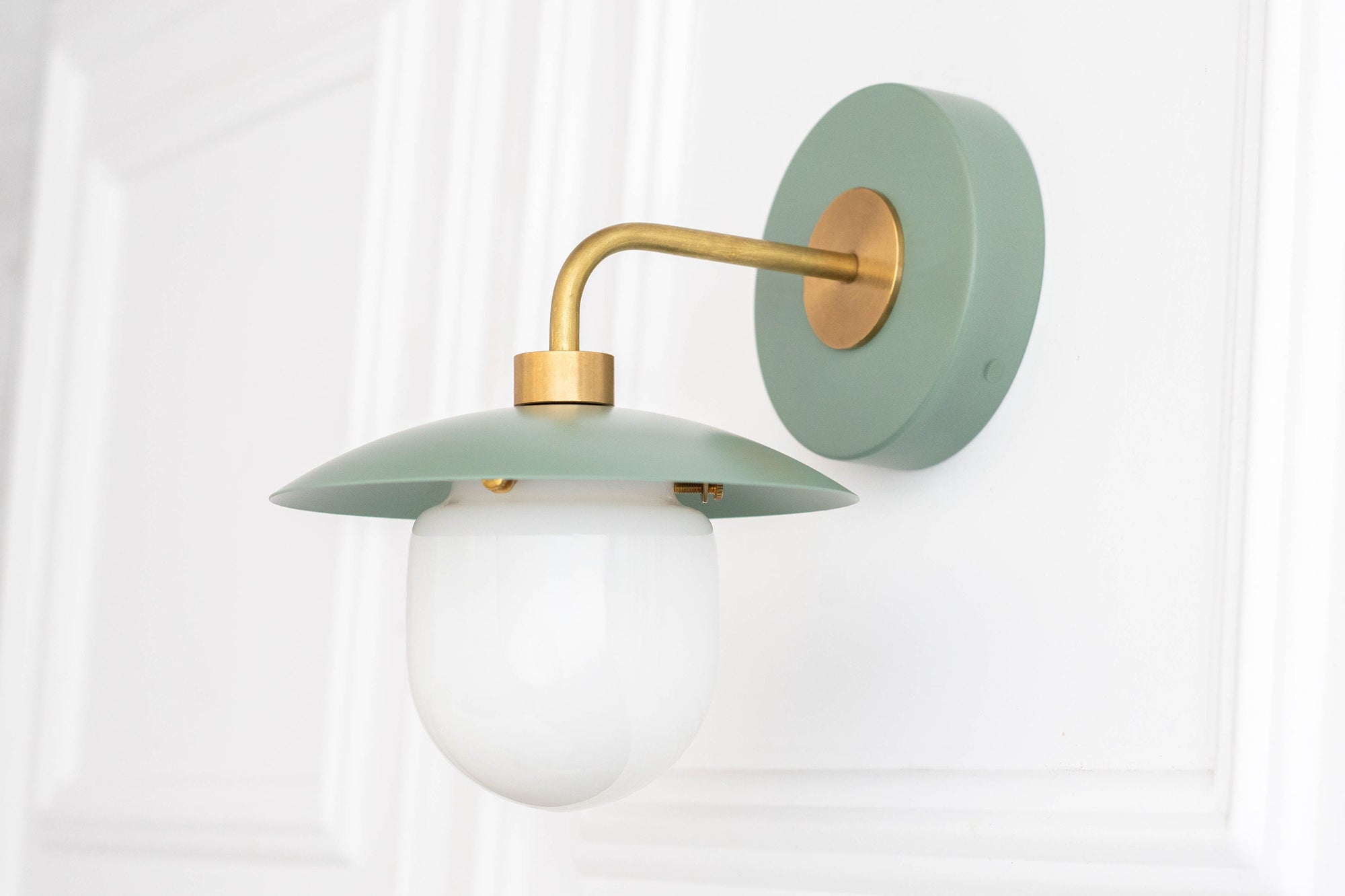 Raw brass and muted green mid-century modern wall sconce with frosted globe shade. - SCONCE MODEL NO. 7039