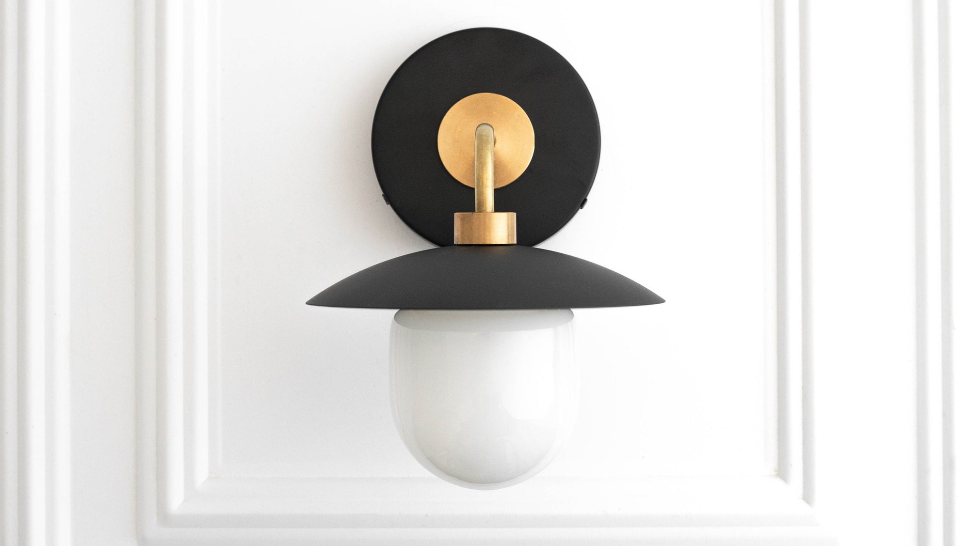 Mid-century modern black and brass wall sconce with white glass globe shade. - SCONCE MODEL NO. 7039