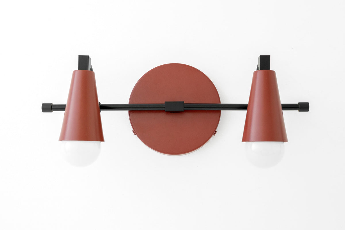 Two-bulb black and brick red industrial vanity light with conical shades and round backplate. - VANITY LIGHT MODEL NO. 1229