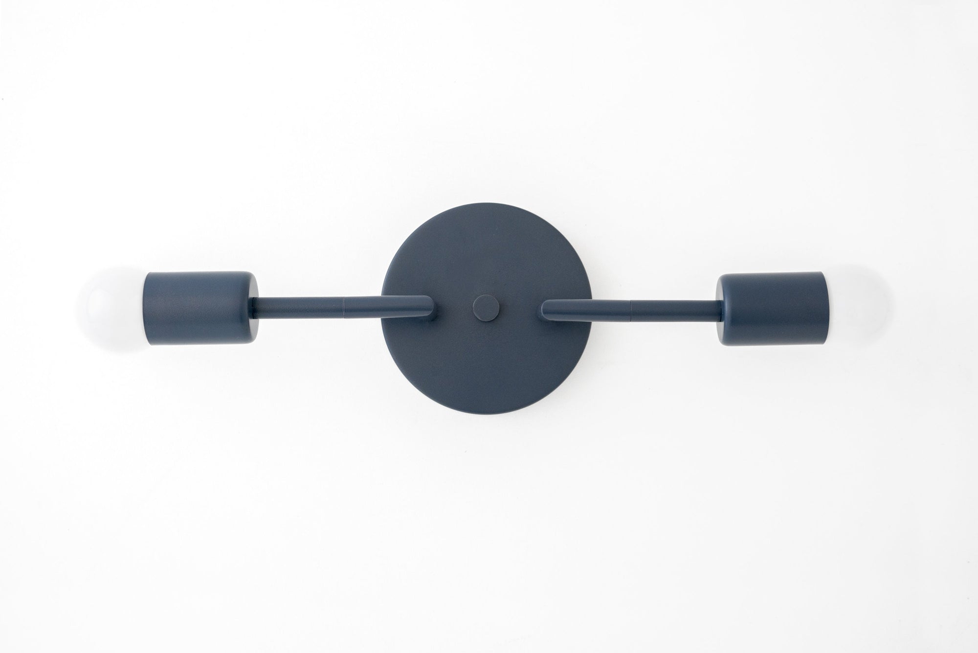 Mid-century modern black metal vanity light with two exposed bulbs and circular wall mount. - VANITY LIGHT MODEL NO. 1938