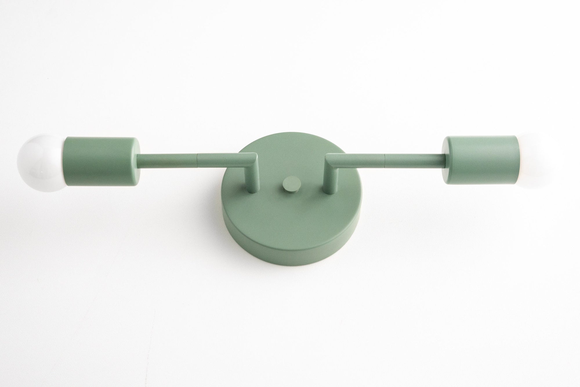 Mid-century modern green vanity light with two bare bulbs and round wall mount. - VANITY LIGHT MODEL NO. 1938