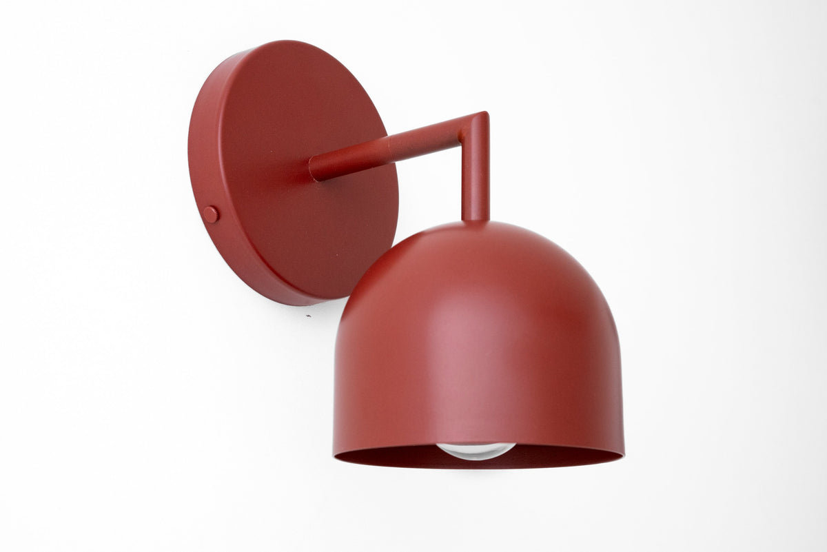 Brick red matte metal wall sconce with dome-shaped shade and exposed bulb design. - SCONCE MODEL NO. 4250