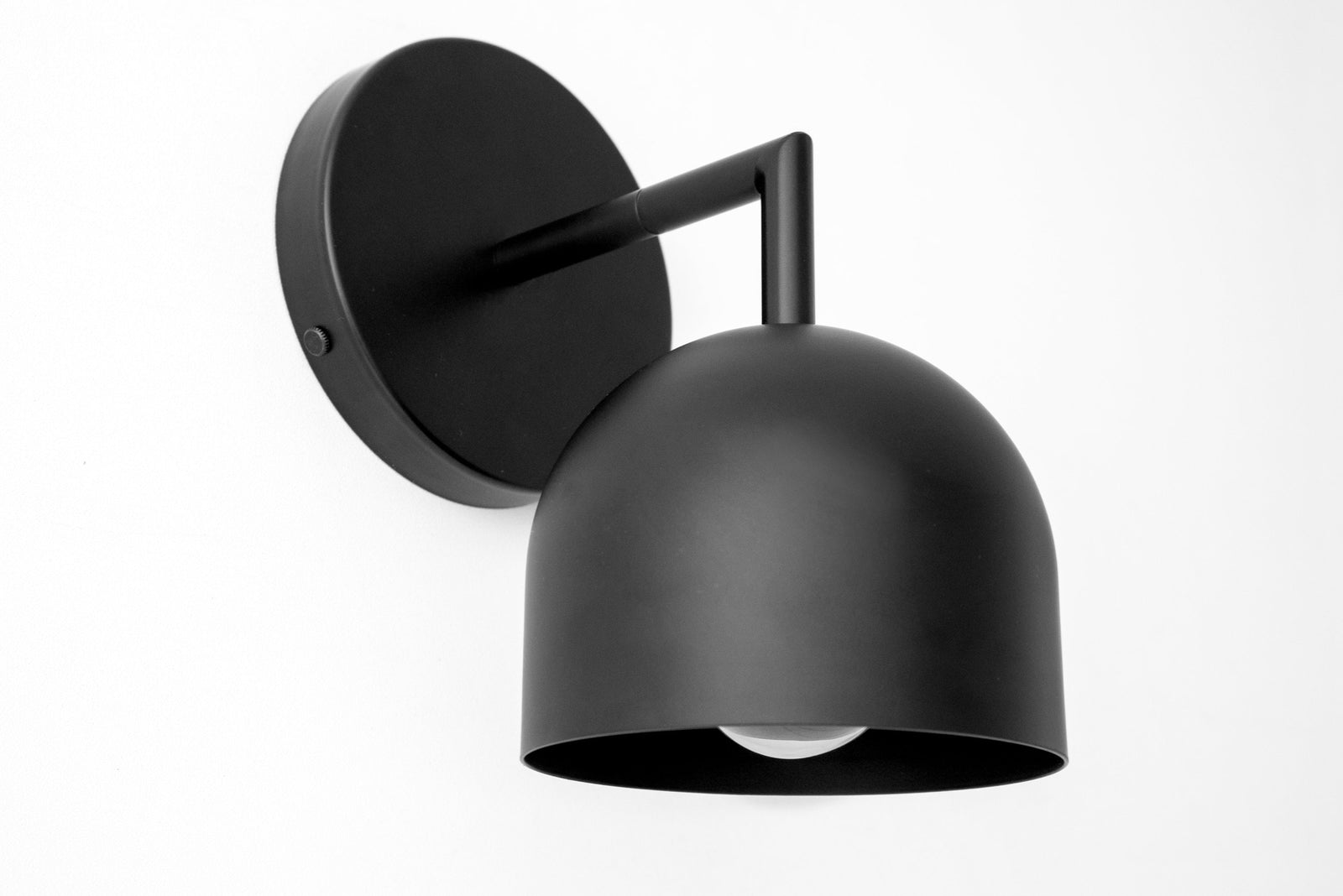 Matte black metal wall sconce with a dome-shaped shade and minimalist arm design. - SCONCE MODEL NO. 4250