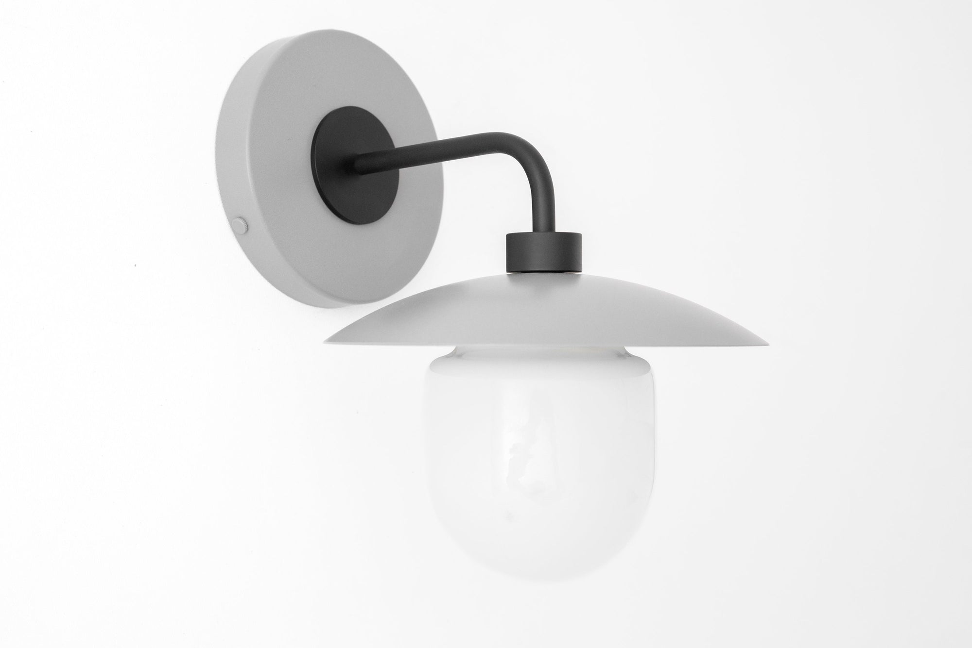 Matte gray semi-flush sconce with black arm and round white globe light. - SCONCE MODEL NO. 7039