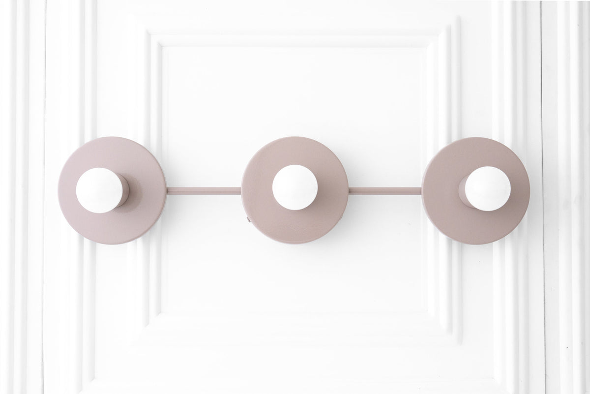 Mid-century modern mauve vanity light with three round bases and exposed white bulbs. - VANITY LIGHT MODEL NO. 5708