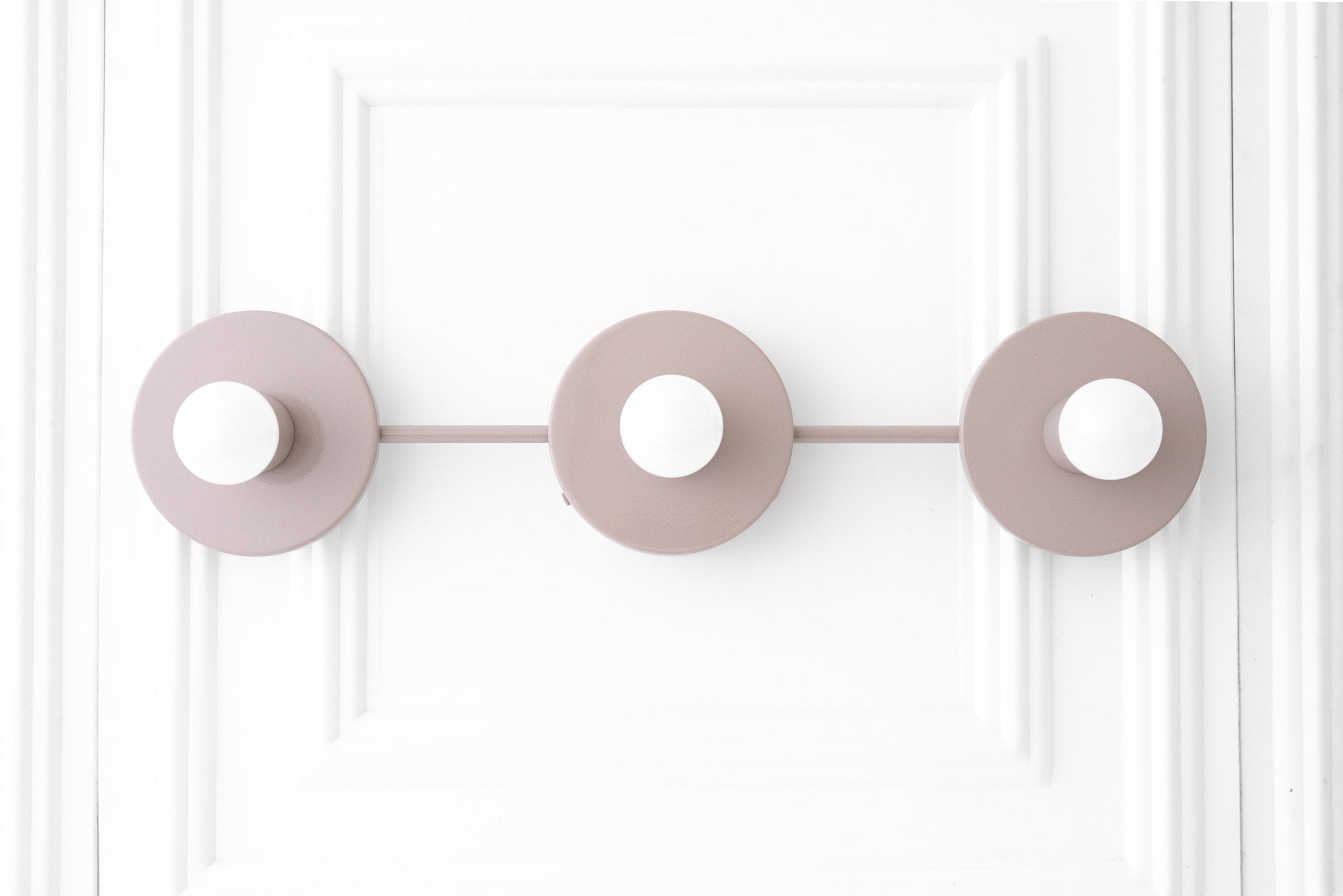 Mauve Scandinavian vanity light with three round bare bulbs on a linear mount. - VANITY LIGHT MODEL NO. 5708