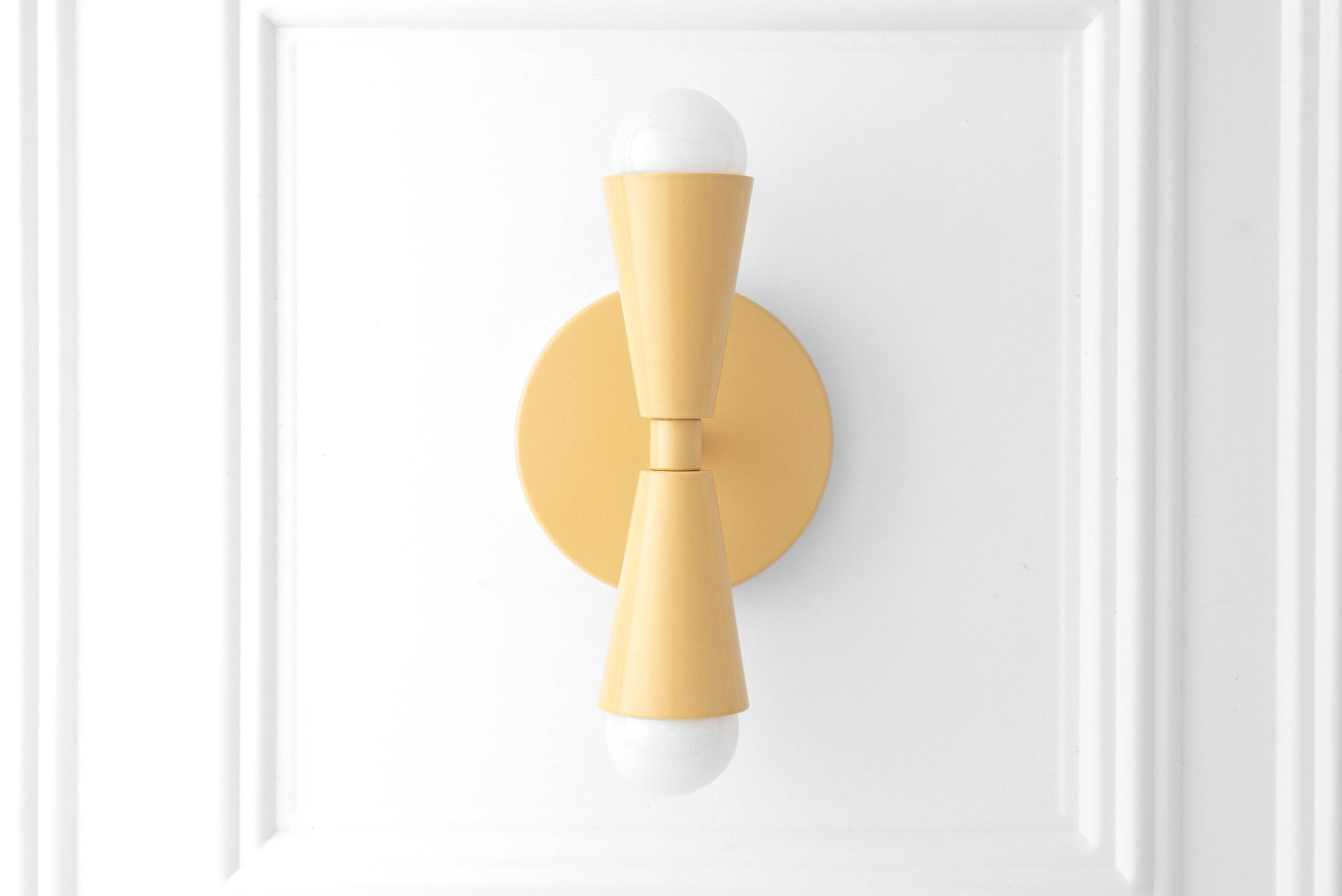 Art Deco yellow semi-flush sconce with exposed bulbs, mounted on white paneled wall. - SCONCE MODEL NO. 4717
