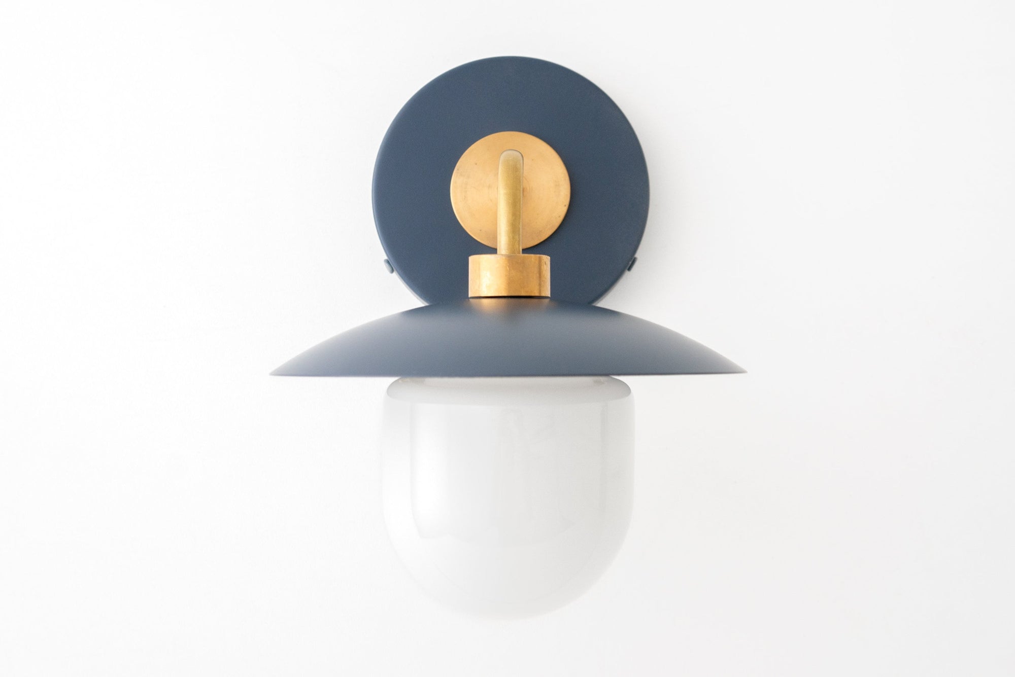 Mid-century modern wall sconce with raw brass mount and matte coal blue shade, frosted globe diffuser. - SCONCE MODEL NO. 7039