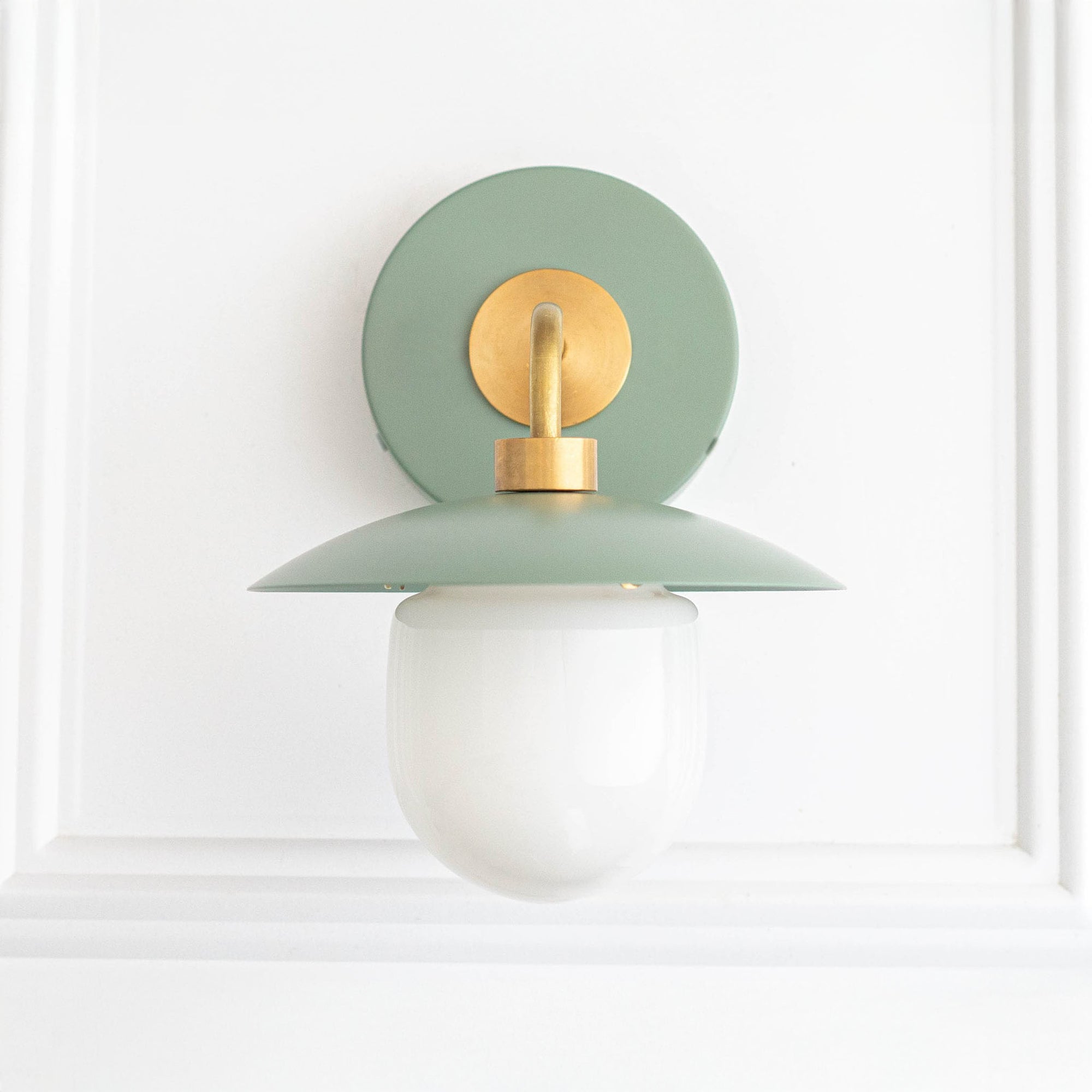 Raw brass and matte green mid-century modern wall sconce with white globe shade. - SCONCE MODEL NO. 7039
