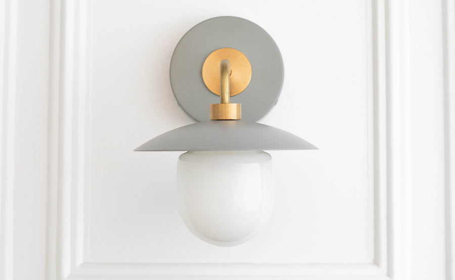 Mid-century modern wall sconce with raw brass mount, matte gray shade, and white globe diffuser. - SCONCE MODEL NO. 7039