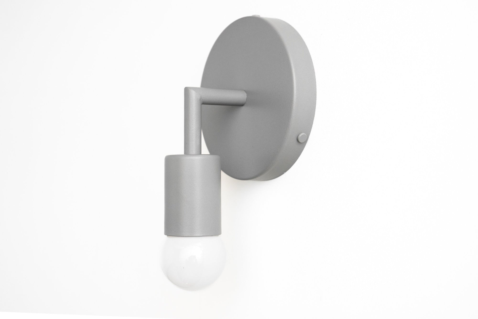Matte light gray Scandinavian-style wall sconce with exposed bulb and cylindrical holder. - SCONCE MODEL NO. 5480
