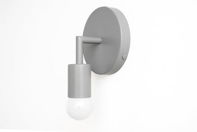 Matte light gray Scandinavian-style wall sconce with exposed bulb and cylindrical holder. - SCONCE MODEL NO. 5480