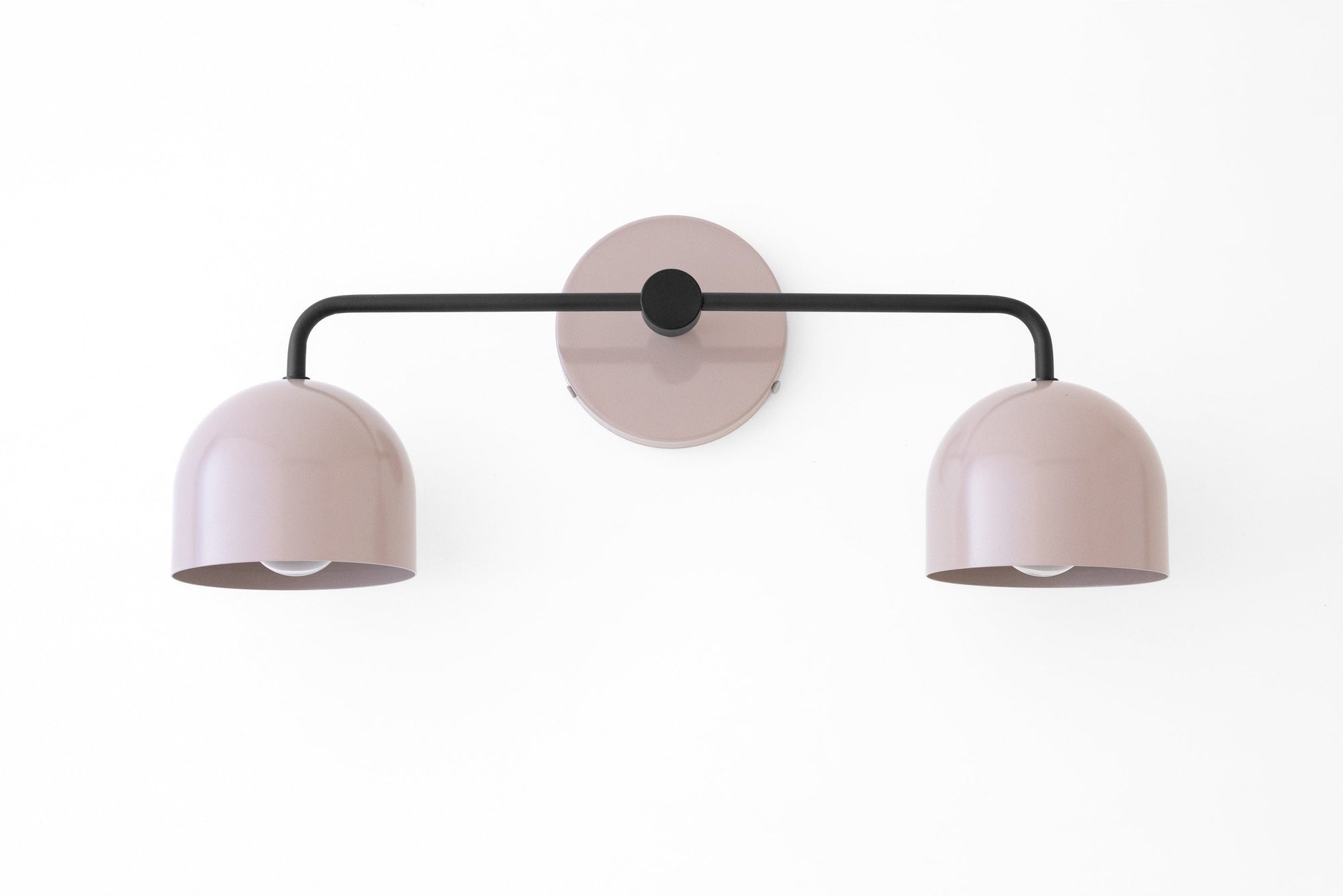 Mid-century modern vanity light with black metal arm and two mauve dome shades mounted on mauve circular base. - VANITY LIGHT MODEL NO. 2082