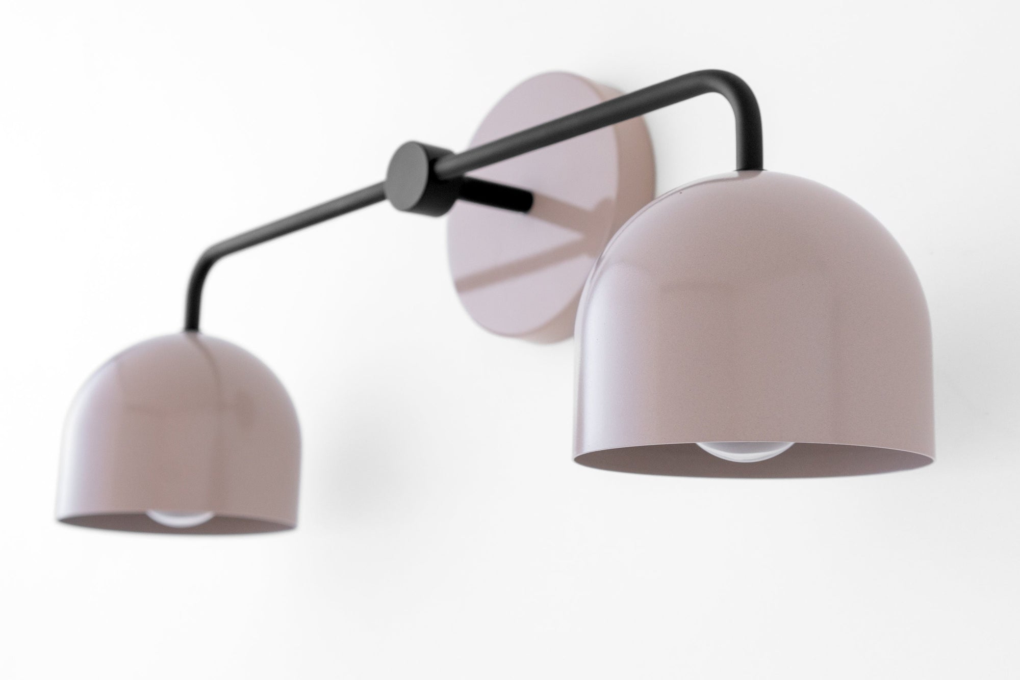 Mid-century modern black vanity light with two mauve dome shades and wall mount plate. - VANITY LIGHT MODEL NO. 2082