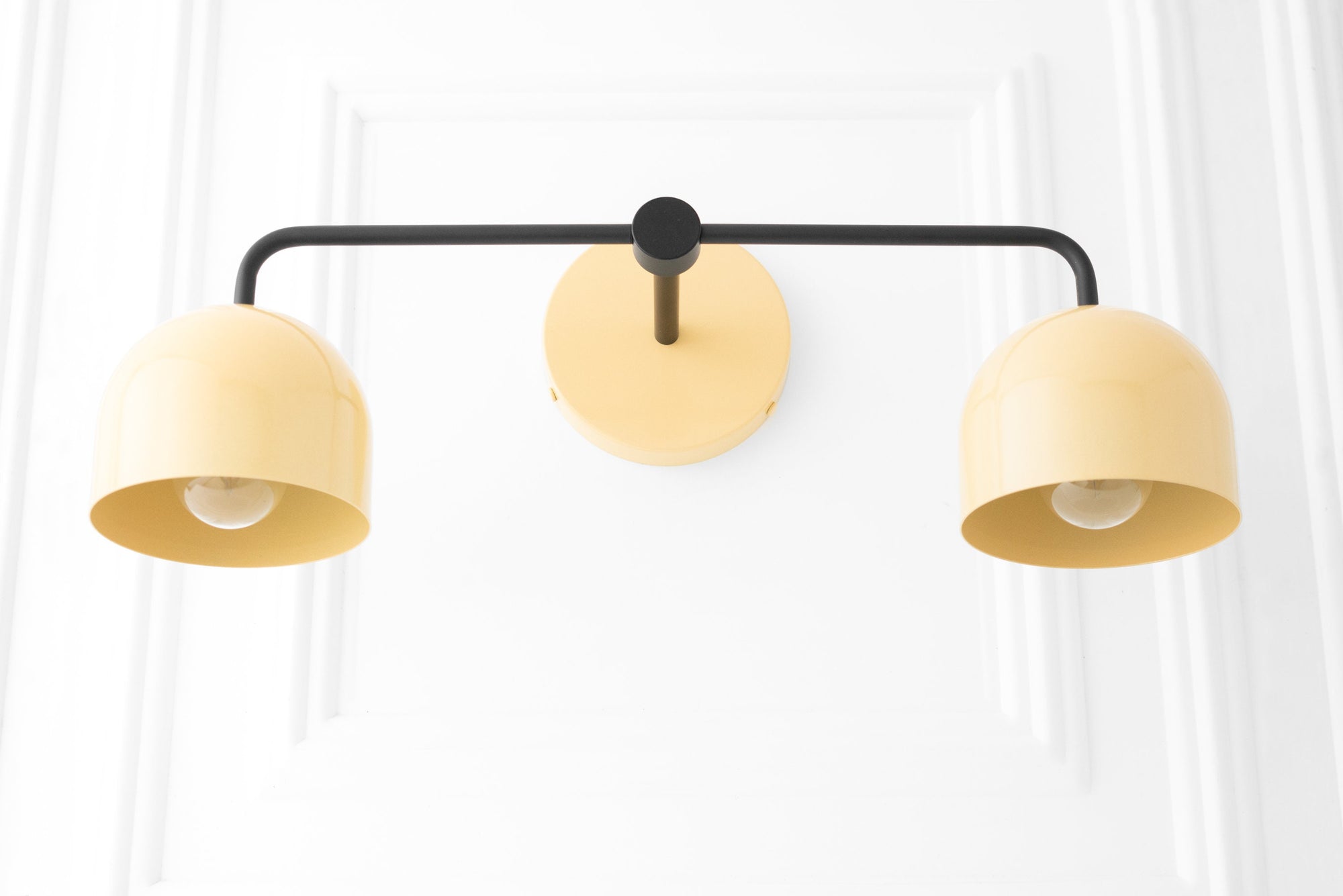 Black and cream mid-century modern vanity light with two dome-shaped shades and round wall mount. - VANITY LIGHT MODEL NO. 2082