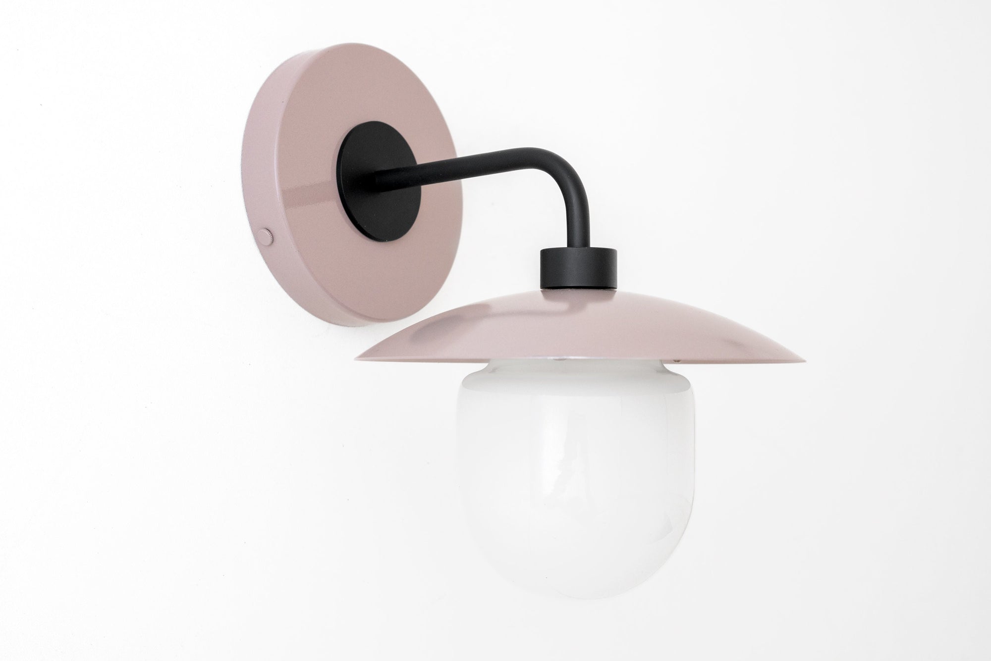 Matte mauve wall sconce with black curved arm and white globe light. - SCONCE MODEL NO. 7039